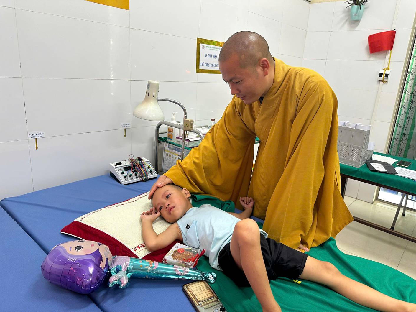 A person in a yellow robe holding a baby

AI-generated content may be incorrect.